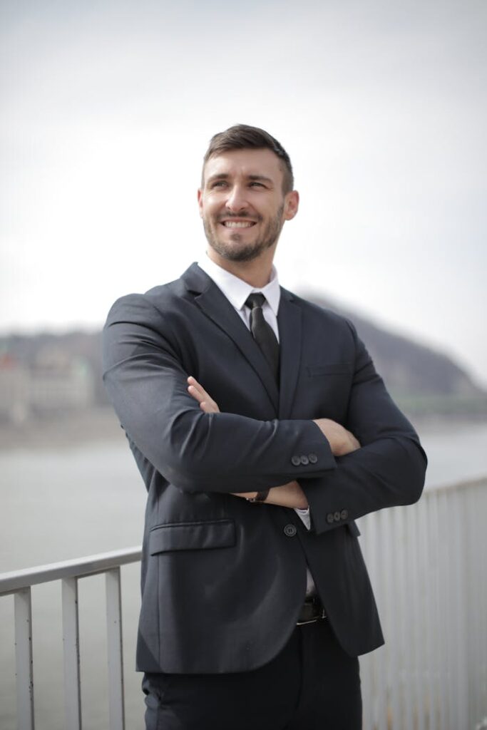 Man in Black Suit Jacket Standing Near Railings